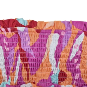 Detail of colorful smocking texture and elasticated floral fabric with ruffle edge