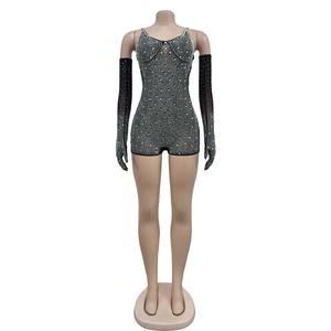 Detail of black mesh jumpsuit with silver rhinestones and matching long gloves