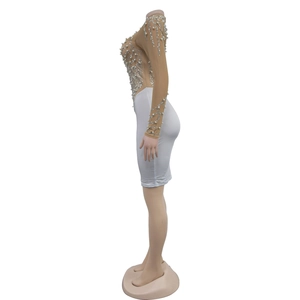 Detail of nude mesh sleeve with silver rhinestones and white pearls on bodycon dress