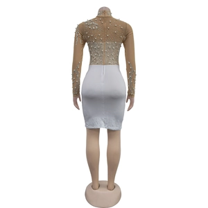 Detail of sheer mesh long sleeves with silver rhinestones and pearls on a white dress