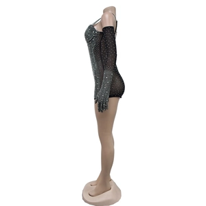 Detail of black mesh jumpsuit with sparkling silver rhinestones and matching gloves