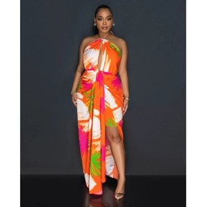 Detail of tropical print halter dress featuring backless tie and high side slit