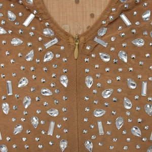 Close-up of sheer mesh fabric with sparkling crystal rhinestones and an invisible zipper