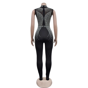 Macro shot of back invisible zipper and silver rhinestone details on the black jumpsuit