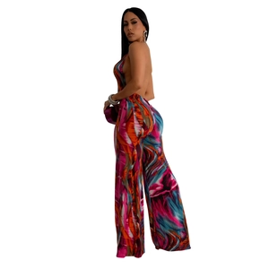 Detail of backless halter jumpsuit with vibrant gradient print and wide-leg cut