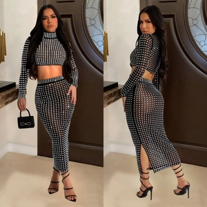 Sparkly two-piece mesh set with rhinestones featuring a crop top and high waist long skirt