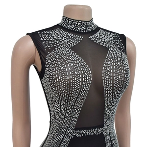 Close-up of black mesh bodysuit featuring sparkling silver rhinestones in geometric patterns