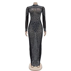 Detailed view of black mesh dress featuring sparkling rhinestones and sheer long sleeves