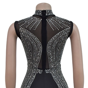 Detail view of rhinestone patterns and zipper on black mesh backless jumpsuit