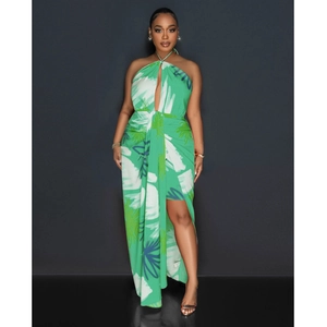 Detail of tropical leaf print on green halter dress with side slit and waist cutout