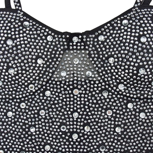 Close-up of sparkling rhinestones and black mesh detail on the sheer jumpsuit bodice
