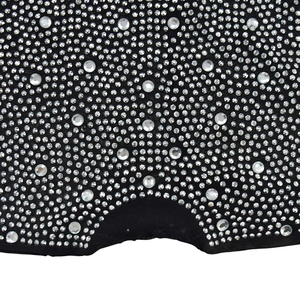 Close-up of black sheer mesh fabric with sparkling rhinestones on the romper jumpsuit