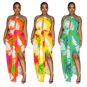 Detail of a backless floral maxi dress with tropical leaf prints and high side slit design