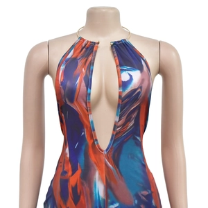 Detail view of the deep V-neck halter jumpsuit with gold chain and abstract print