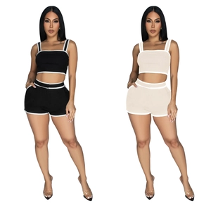 Close-up of sporty two-piece crop top and shorts set with white contrast binding