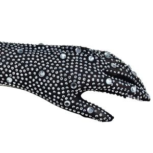 Detail of black mesh gloves with glittering rhinestones and shimmering crystals for party