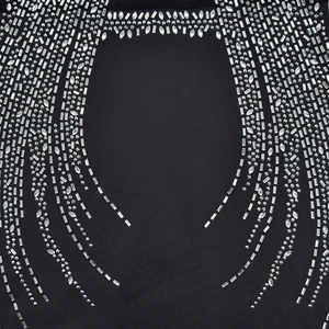 Detailed macro view of silver rhinestones and sequins on premium black mesh fabric