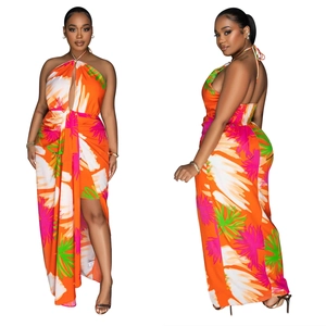 Detail of tropical print halter dress with front cutout and side slit in orange