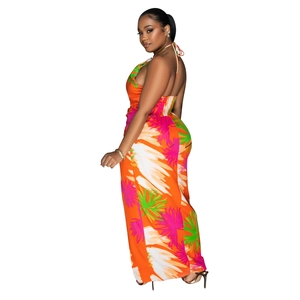 Detail of the backless halter dress showing vibrant tropical palm prints and elastic waist