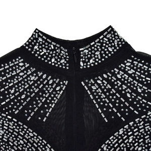 Detail of high collar neckline with rhinestones and back zipper on black mesh jumpsuit