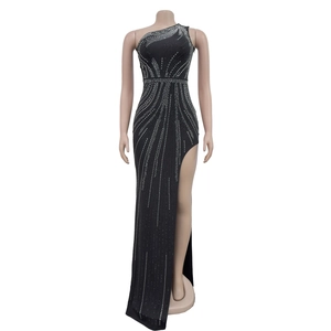 Close-up of radiant silver rhinestones and wavy patterns on black one-shoulder dress