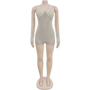 Detail of beige rhinestone bodysuit with matching mesh gloves and sheer fabric