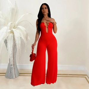 Close-up of red bandeau jumpsuit featuring a U-shaped metal buckle and teardrop cutout
