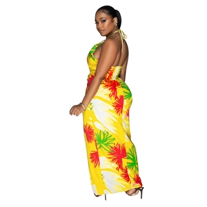 Detail view of backless halter jumpsuit featuring vibrant yellow tropical floral print