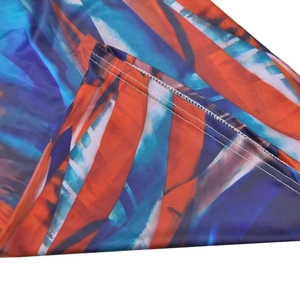 Detail of colorful abstract print fabric with clean double-needle stitching and smooth hem