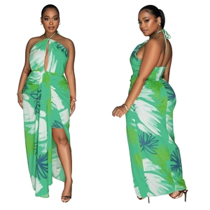 Detailed view of backless halter dress with tropical palm leaf print and high side slit
