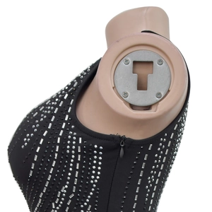 Detailed view of black dress featuring silver rhinestones and an invisible back zipper