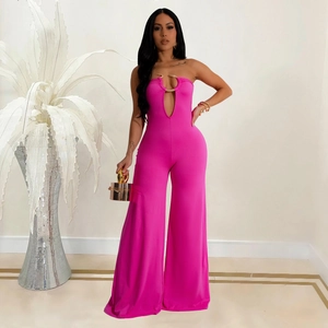 Detail of rose red jumpsuit featuring a deep V-neckline with gold U-shaped metal ring hardware