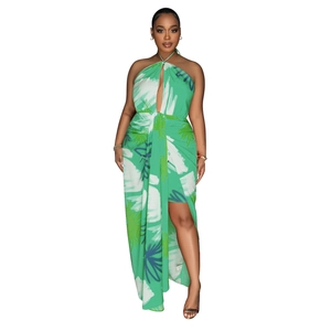 Detail of emerald green backless floral dress showing halter neck and leaf print pattern