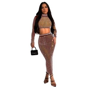 Detail of two-piece dress set showing brown mesh fabric with rhinestone grid patterns