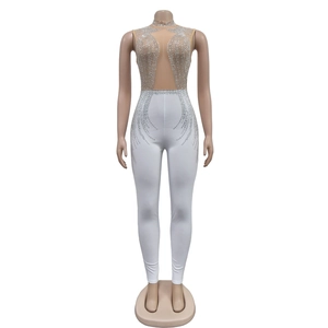 Detailed view of white mesh jumpsuit featuring sparkling rhinestones and sleeveless design