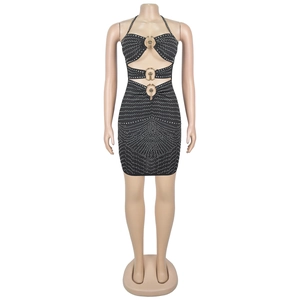 Detail of black rhinestone mini dress featuring sexy cut-outs and golden metal ring accents