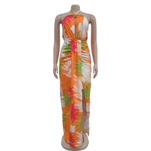 Detail showing tropical floral print and halter neck tie on vibrant orange summer dress