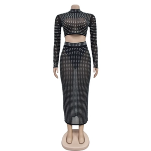 Detail of black mesh two-piece set featuring silver rhinestone grid pattern and sheer texture