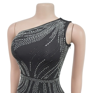 Close-up of sparkling silver rhinestones on a black one-shoulder evening dress