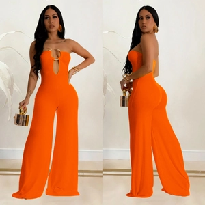 Detail of orange halter neck jumpsuit with gold ring accent and wide-leg cut