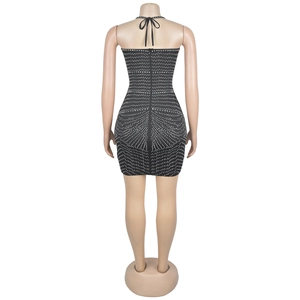 Detail of a black bodycon dress featuring sparkling rhinestones and a back zipper closure