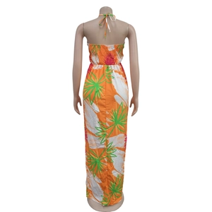 Detail of the back smocked elastic design on the tropical palm leaf halter maxi dress