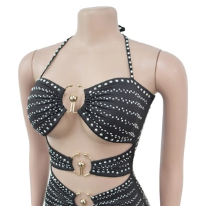 Detail of black rhinestone halter dress with gold metal ring connectors and cut-outs
