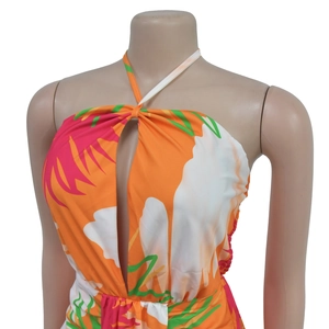 Detail of tropical floral print halter dress with front keyhole cutout and vibrant colors