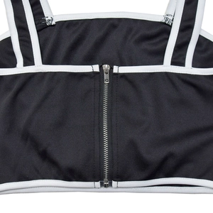 Detailed close-up of a two-tone crop top featuring a front metal zipper and white contrast piping