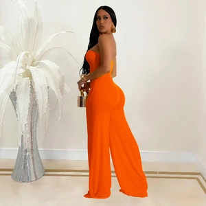 Close-up of bright orange strapless jumpsuit with slim-fit waist and wide-leg design