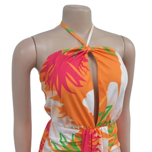 Detail of tropical floral halter dress with keyhole cutout and palm leaf pattern