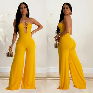 Close-up of vibrant yellow wide-leg jumpsuit with metal ring hollow-out waist detail