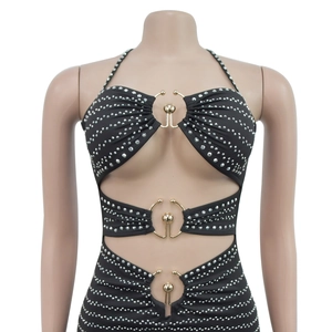 Detail of black rhinestone halter dress with gold metal rings and cutout design