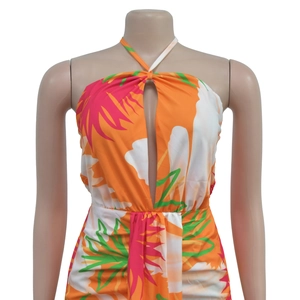 Detail of halter neck tie and cutout bust on a tropical print backless maxi dress